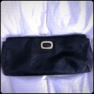 Hobo clutch in back with gold accent
